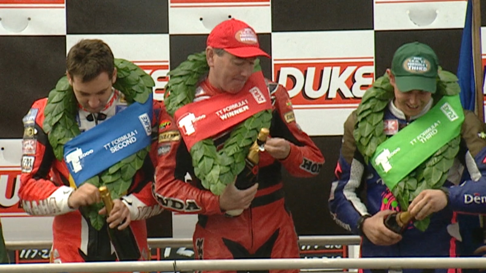 Joey Dunlop joined on the podium by Michael Rutter & John McGuinness